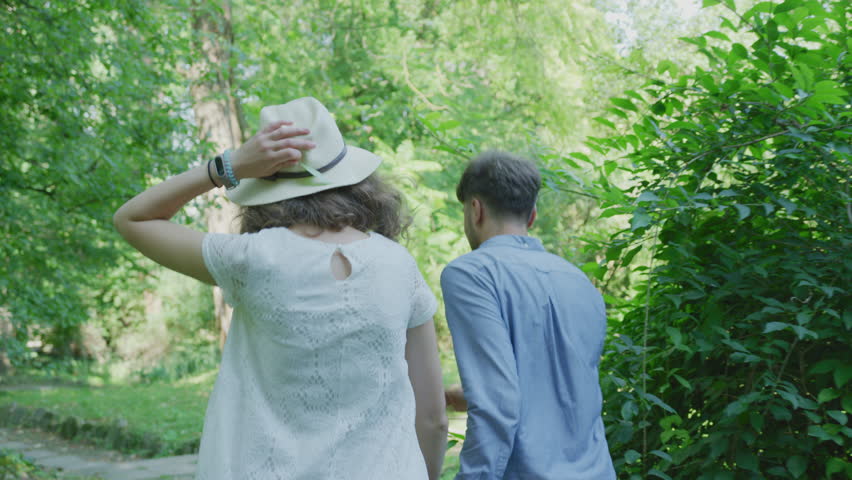 Young couple running together in a park.