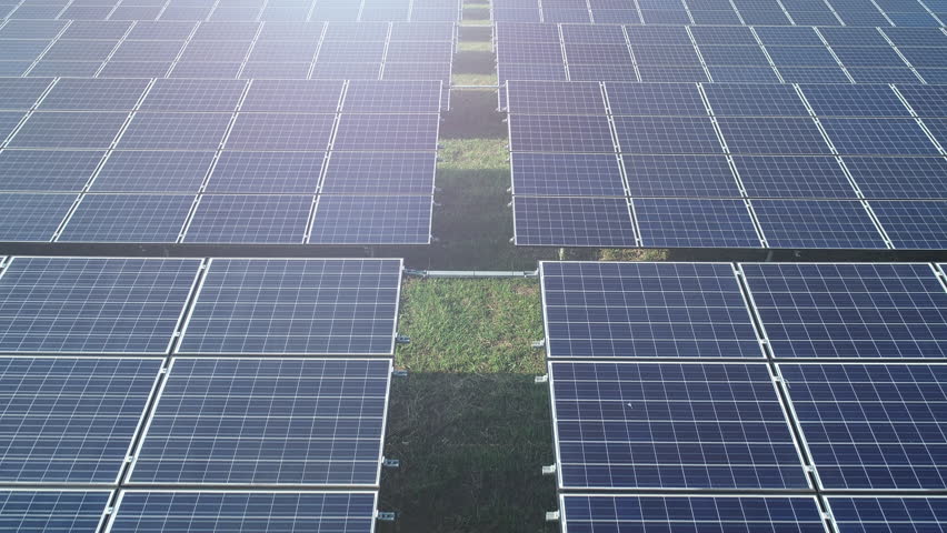 4K Aerial view shot of Solar Panels Farm (solar cells) with sunlight.Drone flight fly over top view of solar panels field renewable green alternative energy concept in Thailand. | Shutterstock HD Video #1018260895