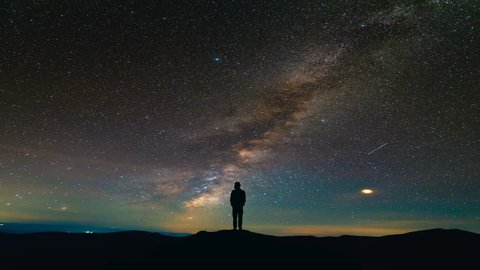 The man standing on the meteor shower background. time lapse