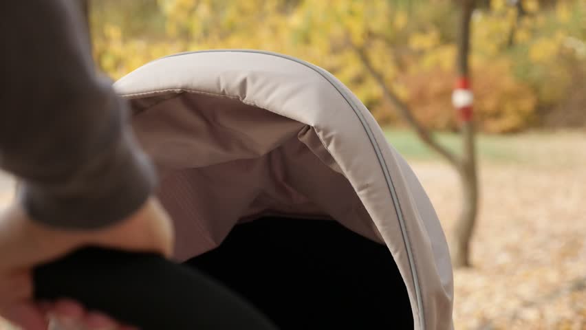 Child being pushed in a modern perambulator close-up video