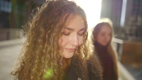 charming blonde sisters are strolling on streets of small city in sunny weather in autumn, close-up - Powered by Shutterstock - Get 15% off with code: PIKWIZARD15