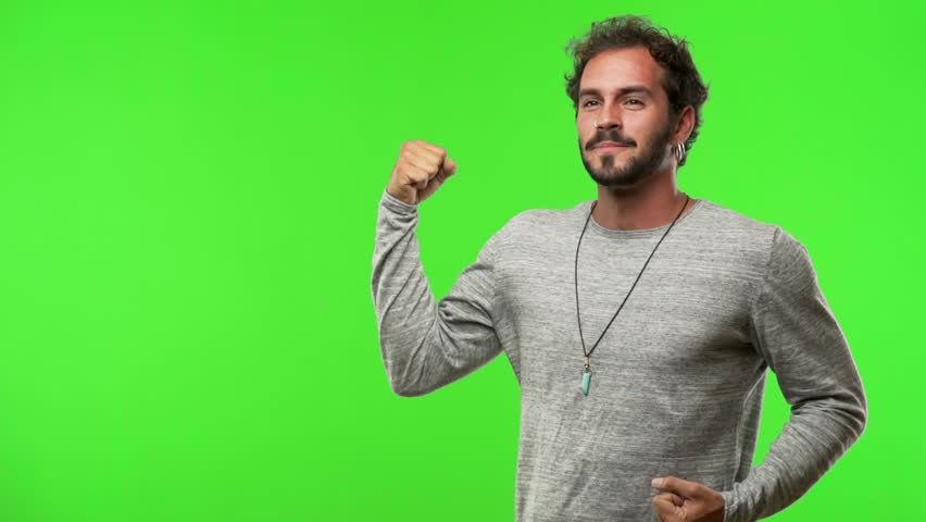 Young man on green chroma who does not surrender, shows power and dissatisfaction, dreams of fulfilling his goals