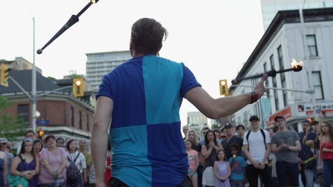 Ottawa, Ontario / Canada - 06 25 2018: A juggler performs in front of a crowd at Ottawa's annual Glow Fest on Bank Street
