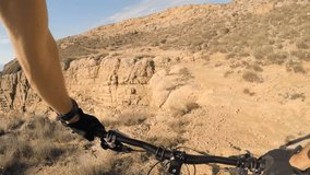 Man riding enduro mountain bike on rocky trail at the seaside in Croatia. View from first person perspective POV. Gimbal stabilized video. 