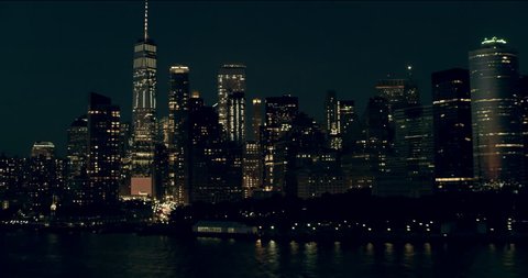 Aerial pan of downtown Manhattan skyscrapers and buildings, New York City, dark summer night light. Wide shot. 4k shot with a RED camera.