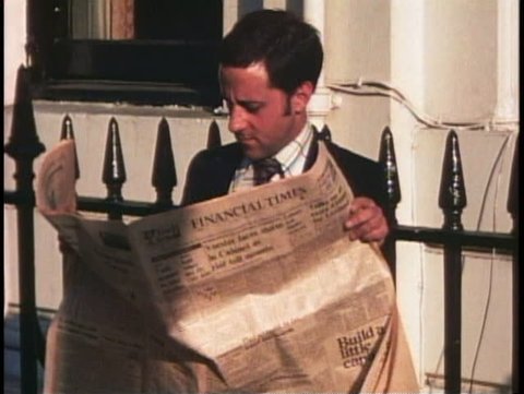 LONDON, ENGLAND, 1976, Man reads Financial Times, closeup of face