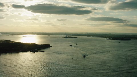 Aerial view of Upper Bay leading to Ellis Island, New York City, bright sun light. Wide shot. 4k shot with a RED camera.