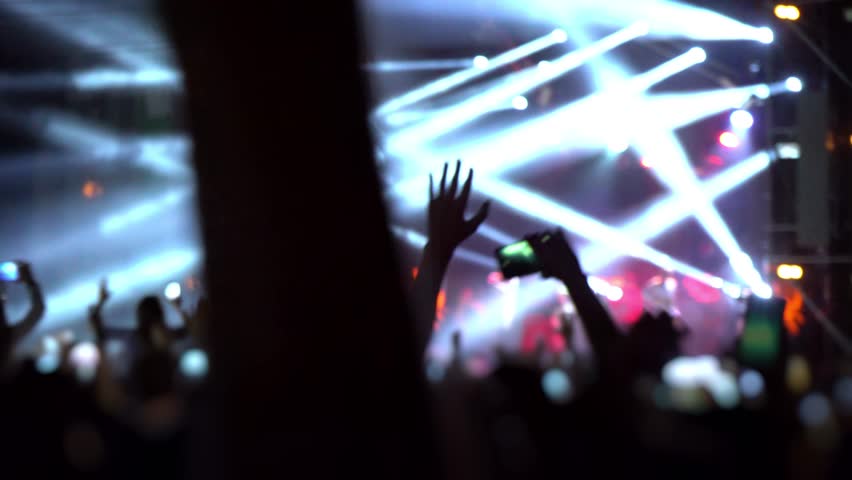 Happy people are watching an amazing musical concert. Merry fans jump and raise their hands up.
Crowd of excited fans applauding to popular band performing favorite song. A group of fans with phones Royalty-Free Stock Footage #1018316962