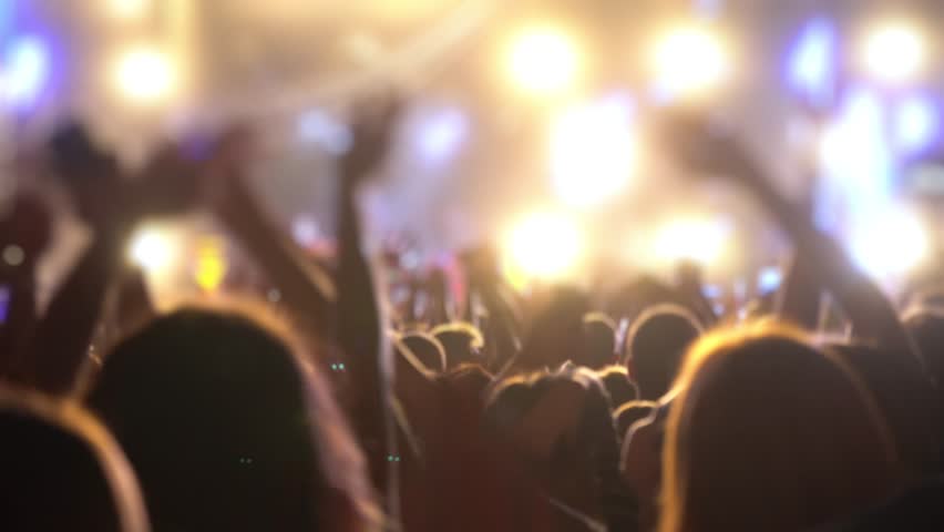 Happy people are watching an amazing musical concert. Merry fans jump and raise their hands up.
Crowd of excited fans applauding to popular band performing favorite song. A group of fans with phones Royalty-Free Stock Footage #1018317007