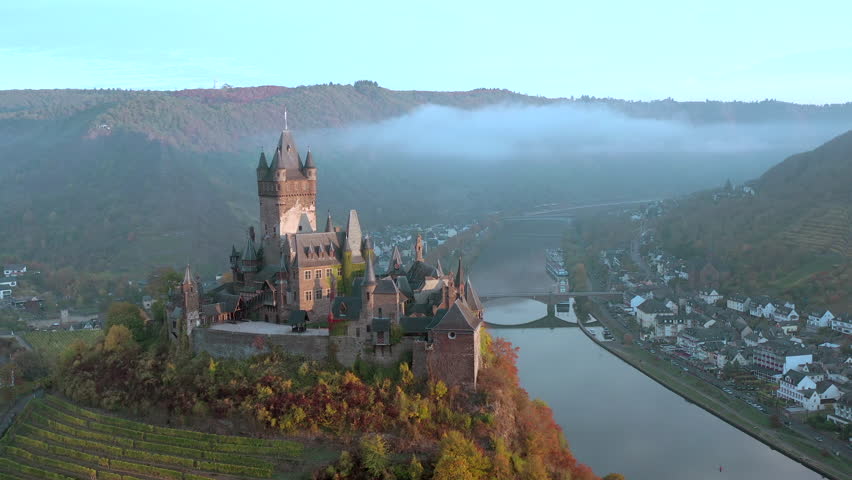 Sunrise Aerial View of the Town of Cochem and the Castle Overlooking the Beautiful Riverside City in the Autumn Royalty-Free Stock Footage #1018318081