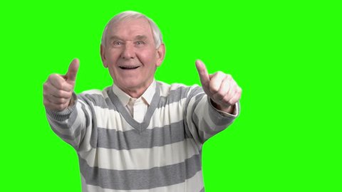 Front view of two thumps up from old man. Merry grandpa with thumbs up in green hromakey background.