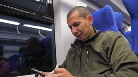 traveler unknown middle-aged man smartphone in the subway writes sms to social media messenger. slow motion video. man metro in railway train. man traveler in lifestyle train concept travel