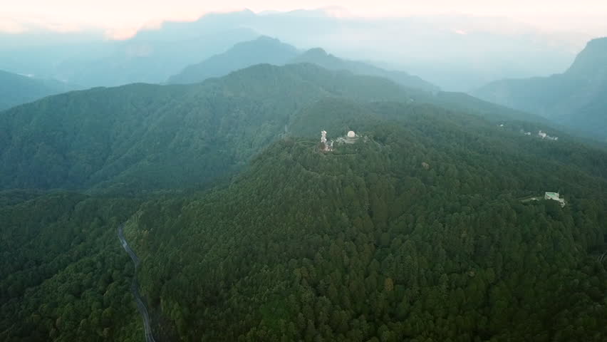 Aerial shot above the green forest of Alishan Mountain in Taiwan.