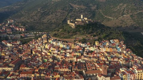 Video from above, aerial view of the beautiful village of Bosa with colored houses and a medieval castle. Bosa is located in the north-wesh of Sardinia, Italy.