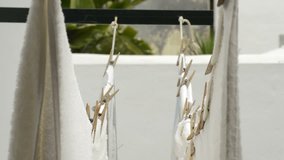 Domestic laundry hanging on a clothesline fastened with old wooden clothespins