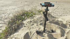 A hand-held classic mechanical video stabilizer on the blue beach background