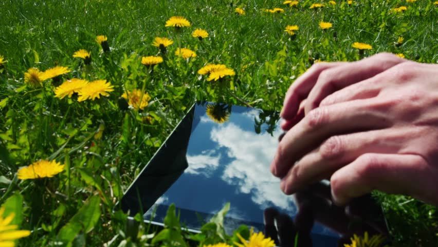 Man using tablet pc outdoors.