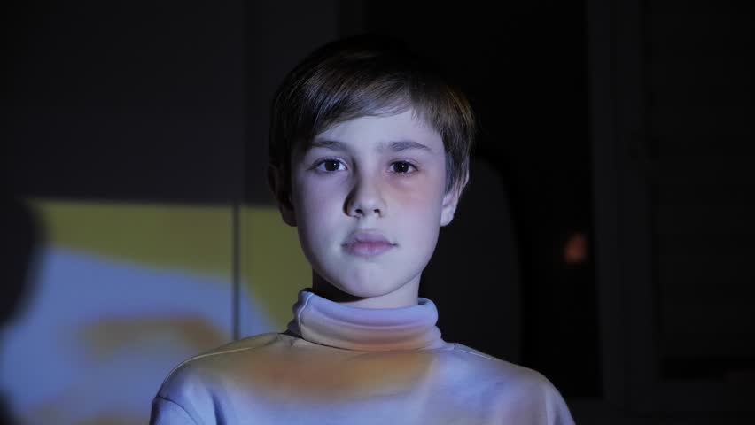 Little boy watching TV in the Dark