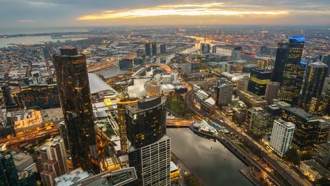A aerial view of Melbourne cityscape including Yarra River and Victoria Harbour in the distance. Timelapse during sunset with beautiful sun ray bursting through fast moving clouds.
Timelapse Zoom Out