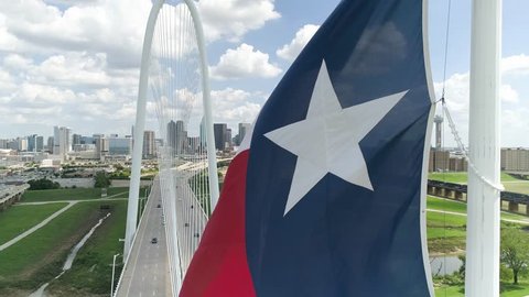 4K Texas Flag Slow Motion with Dallas Skyline In Background Aerial