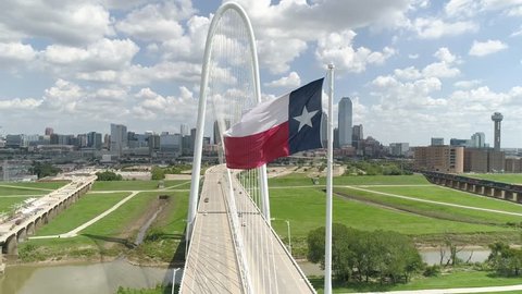 4K Texas Flag Slow Motion with Dallas Texas Skyline in Background