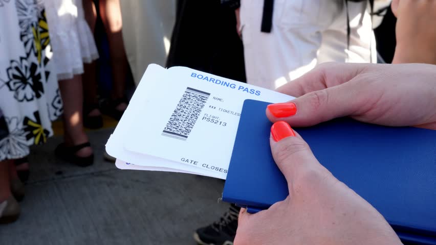 Close-up, female hands holding Airline boarding pass tickets, Boarding pass and passport at airport Royalty-Free Stock Footage #1018388188