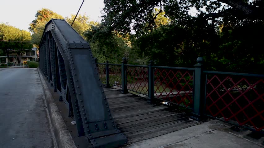 A pan across from a bridge in the King William district in San Antonio, Texas over the riverwalk.