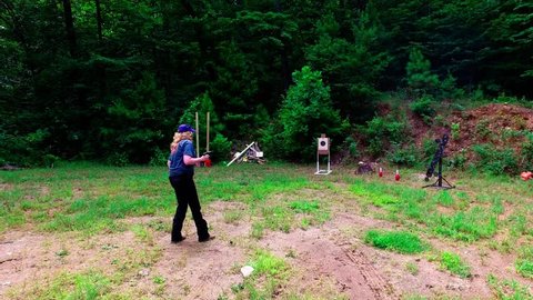 Jasper, GA / United States - 07 23 2018: Woman practicing at outdoor pistol target range