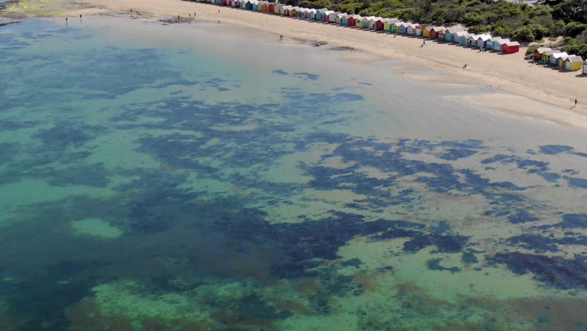 Aerial of Brighton Bathing Boxes in Melbourne from the ocean, reveal shot
