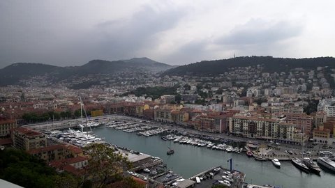 Shot of Nice harbour with yachts and cars. Luxury resort lifestyle and travel. Left to right pan real time establishing shot