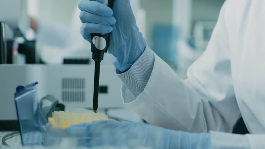 Close-up of the Female Scientist's Hand in Glove Using Micro Pipette while Working with Test Tubes. People in Innovative Pharmaceutical Laboratory Study Genetics and Pharmaceutics. | Shutterstock HD Video #1018403167