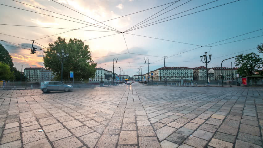 Turin traffic street at sunset on Ponte Vittorio Emanuele I in front of Piazza Vittorio Veneto , Italy.