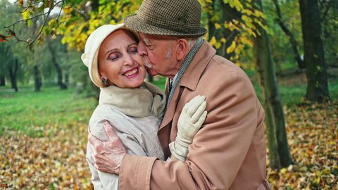 Elderly man kissing hands of wife