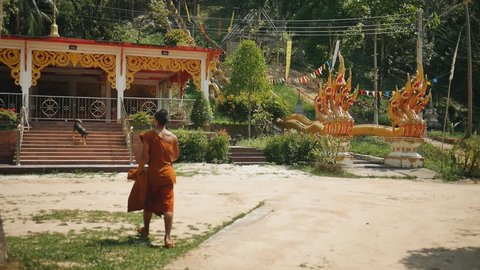 Monk goes to prayer in the Asian temple