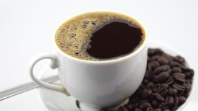 rotating of black coffee in white cup on white background
