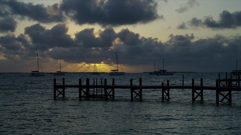 View of remote ocean water with jetty and sailing boats in luxury resort travel outdoor at sunset Bahamas America RED WEAPON
