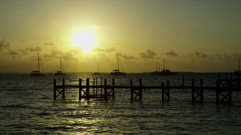 Scenic view of tropical jetty and sailing boats on ocean in Caribbean luxury resort travel at sunset Bahamas America RED WEAPON