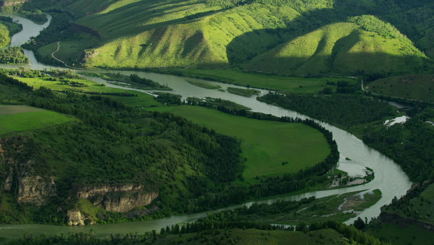 Aerial view of lush green Canyon landscape fertile agricultural farmland Snake river valley wilderness evergreen pine forests Idaho USA RED WEAPON