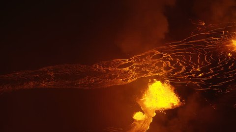 Aerial golden hot liquid lava from open fissures pouring towards Pacific ocean lava rock cooling and solidifying toxic steam rising Kilauea Hawaii USA RED WEAPON