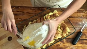 Woman is cooking apple pie, top view slow motion video