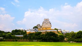 Himeji, Japan. A time-lapse video with a view of the ancient white hilltop Himeji Castle in Himeji, Japan, on a sunny day with a cloudy blue sky.