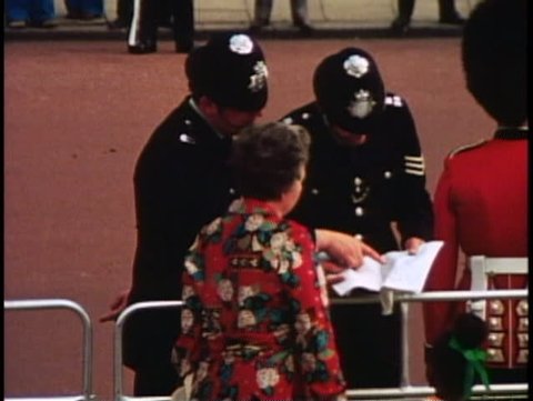LONDON, ENGLAND, 1976, two bobbies, policemen, direct a tourist, 1970s