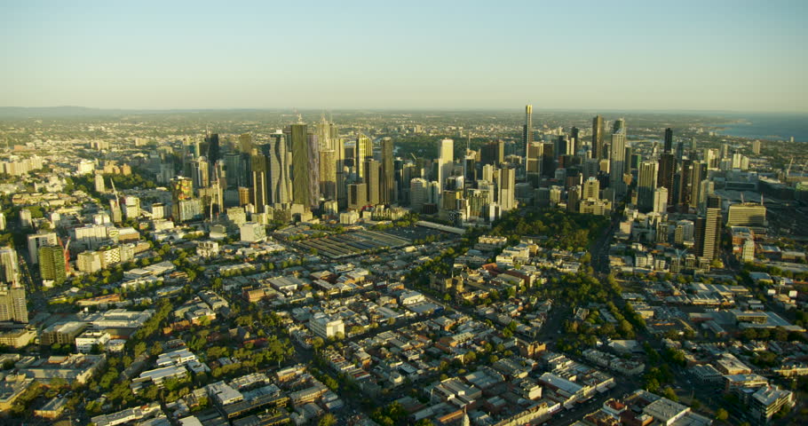 Aerial view at sunset commercial skyscrapers of Melbourne city skyline with historic landmark Queen Victoria Market Australia