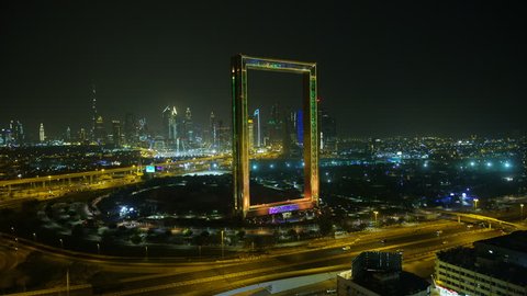 Dubai - March 2018: Aerial city view of the illuminated Dubai Frame at night architectural landmark Zabeel Park Sheikh Zayed road intersection RED WEAPON