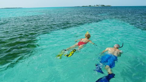 Active senior Caucasian American couple snorkeling underwater and enjoying adventure Summer vacation swimming together Bahamas USA RED WEAPON