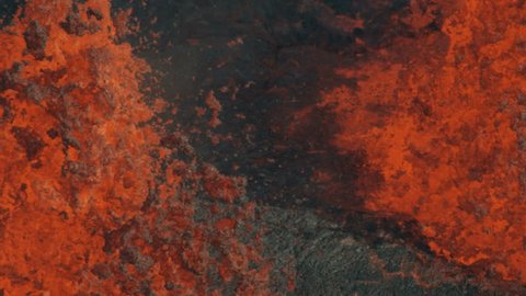 Aerial view of red hot magma pouring from the earths crust with lava rock solidifying on landing a natural phenomenon RED WEAPON