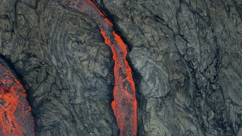 Aerial view of textured lava rock solidifying and cooling red hot lava rivers of liquid volcanic material pouring from the earths crust RED WEAPON