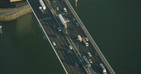 Aerial sunrise view vehicles crossing Yarra River on steel box girder cable stayed West Gate Bridge Melbourne Australia