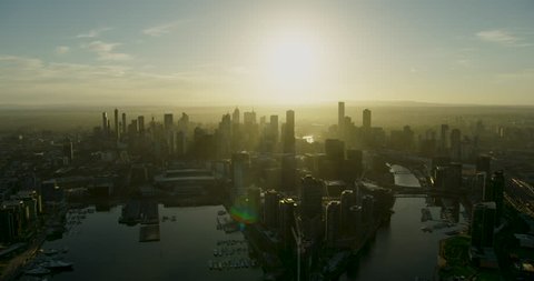 Aerial view at sunrise around Docklands and Yarra River with skyscrapers of Melbourne city skyline Victoria Australia