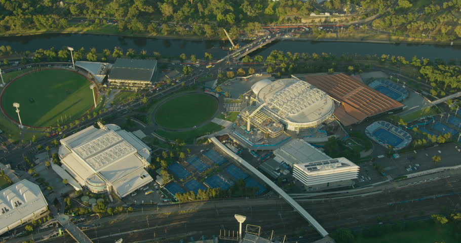 Aerial sunrise view sports and entertainment arenas of Melbourne Park with Swan Street Bridge Yarra River Victoria Australia